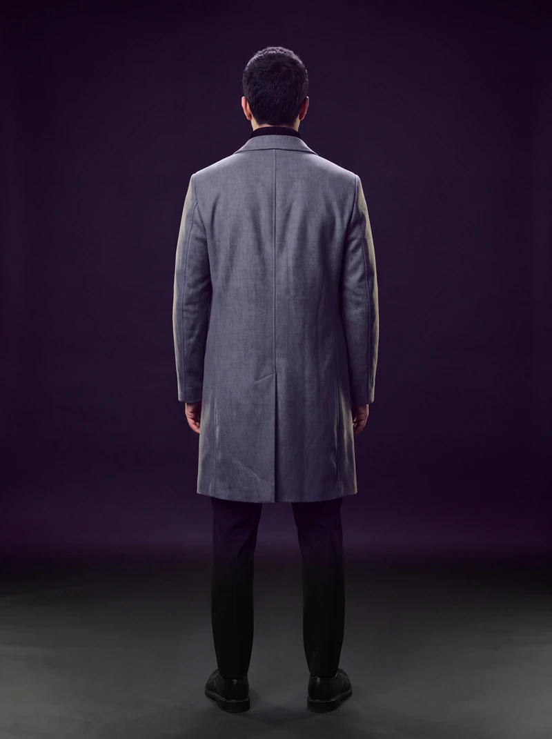 The same man and overcoat seen from behind