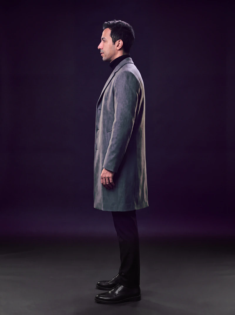 The same man and overcoat in side profile